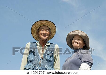 Stock Photo - Farmer Couple Against Sky. Fotosearch
