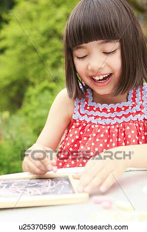 Stock Photo - Girl Drawing on Black Board. Fotosearch