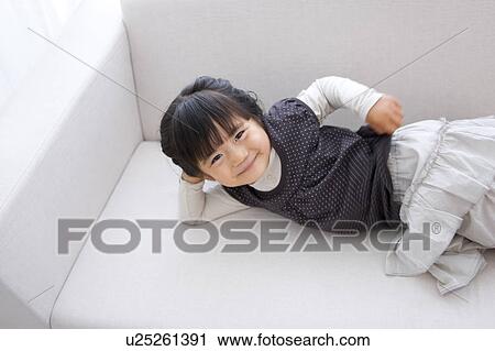 Girl Lying On Sofa, High Angle View View Large Photo Image Stock Image - Girl Lying On Sofa, High Angle View. Fotosearch
