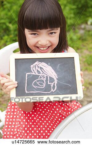 Stock Photography - Girl Showing Her Drawing on Blackboard. Fotosearch