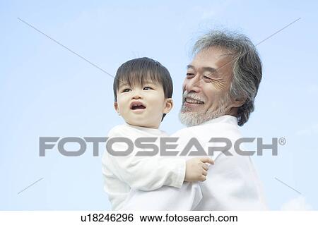 Stock Photograph - Grandfather and Grandson Against Blue Sky. Fotosearch
