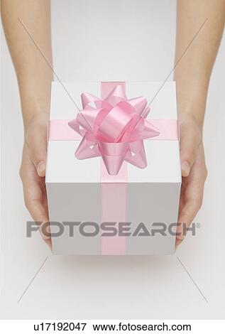Hand holding gift with pink ribbon View Large Photo Image Stock Photo - Hand holding gift with pink ribbon. Fotosearch
