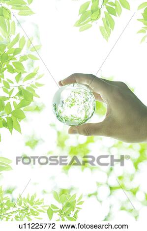 Stock Image - Hand Holding Up Glass Globe. Fotosearch