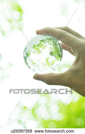 Stock Photo - Hand Holding Up Glass Globe. Fotosearch