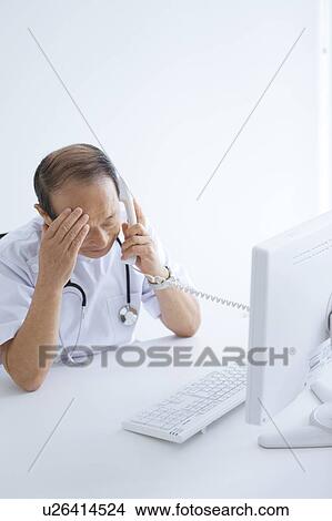 Picture - Male Doctor On The Phone. Fotosearch