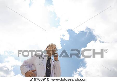 Stock Image - Male Doctor On The Phone. Fotosearch