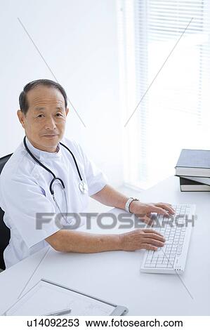 Stock Image - Male Doctor Typing. Fotosearch