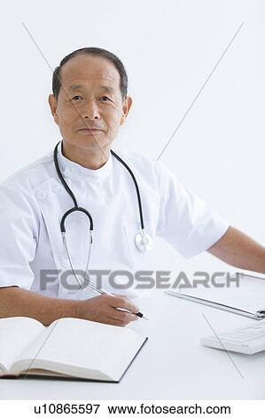 Stock Photo - Male Doctor Working in Office. Fotosearch