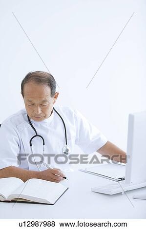 Stock Photo - Male Doctor Working in Office. Fotosearch