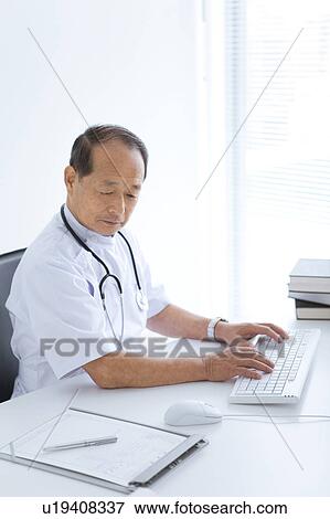 Stock Photo - Male Doctor Working in Office. Fotosearch