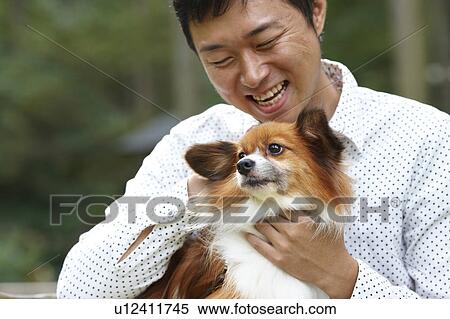 Man Stroking His Pet Papillon Dog View Large Photo Image Stock Photography - Man Stroking His Pet Papillon Dog. Fotosearch