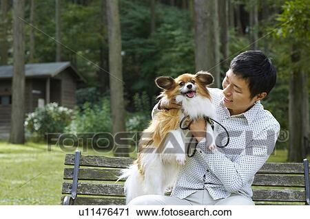 Stock Image - Man with Papillon Dog. Fotosearch