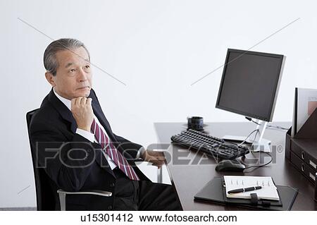 Stock Image - Mature Business at Desk. Fotosearch