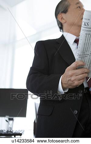 Picture - Mature Businessman with Newspaper. Fotosearch