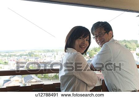 Stock Image - Mature Couple at Balcony. Fotosearch