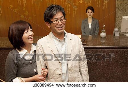 Mature Couple at Hotel Reception View Large Photo Image Picture - Mature Couple at Hotel Reception. Fotosearch