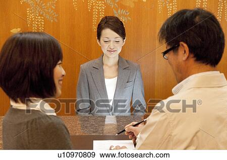 Mature Couple at Hotel Reception View Large Photo Image Stock Photo - Mature Couple at Hotel Reception. Fotosearch