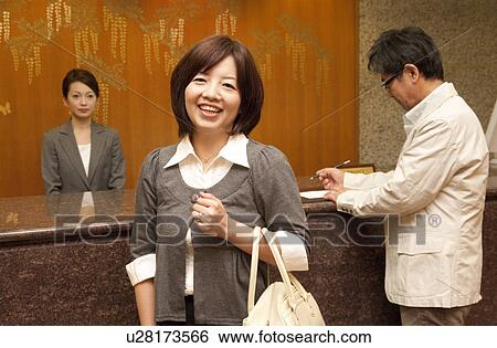 Stock Photograph - Mature Couple at Hotel Reception. Fotosearch