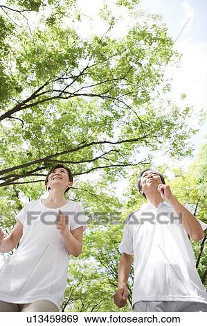 Stock Photo - Mature Couple Jogging in Park. Fotosearch