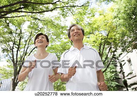 Mature Couple Jogging in Park View Large Photo Image Stock Photo - Mature Couple Jogging in Park. Fotosearch
