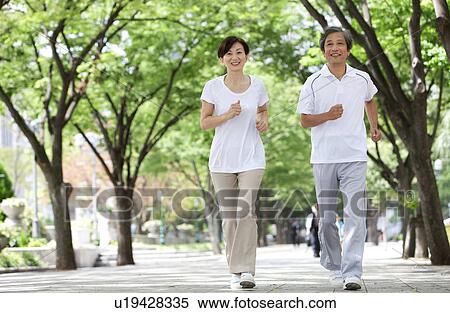 Stock Photography - Mature Couple Jogging in Park. Fotosearch