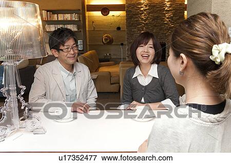 Stock Photo - Mature Couple Talking To Consultant. Fotosearch