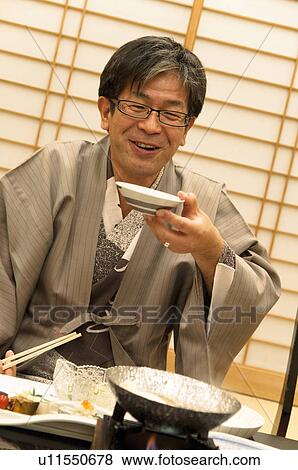 Stock Photo - Mature Man Having Dinner. Fotosearch