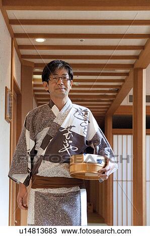 Stock Image - Mature Man in Yukata Carrying Bucket. Fotosearch