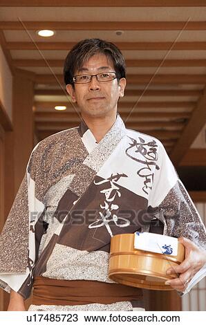 Stock Image - Mature Man in Yukata Carrying Bucket. Fotosearch