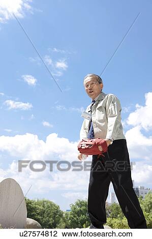 Stock Image - Mature Man Playing Baseball. Fotosearch