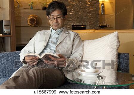 Stock Photo - Mature Man Reading Book. Fotosearch