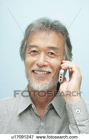 Stock Photo - Mature Man Using Mobile Phone. Fotosearch