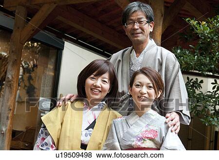 Stock Photo - Mature Woman and Man with Adult Daughter. Fotosearch
