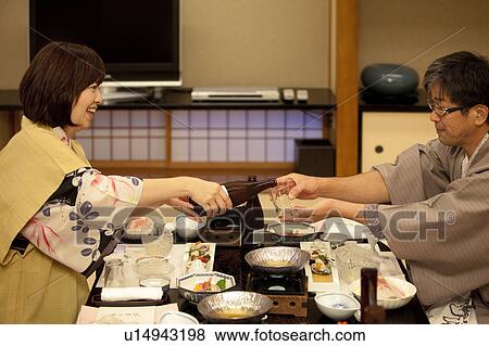 Mature Woman Pouring Beer For Husband View Large Photo Image Stock Photo - Mature Woman Pouring Beer For Husband. Fotosearch