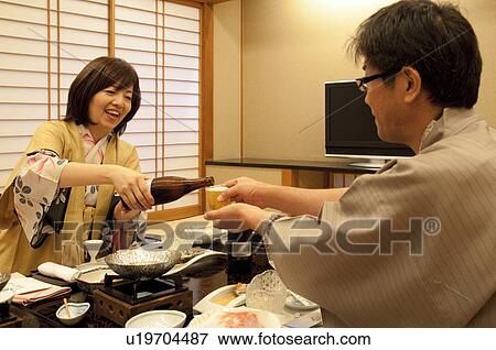 Mature Woman Pouring Beer For Husband View Large Photo Image Stock Photo - Mature Woman Pouring Beer For Husband. Fotosearch