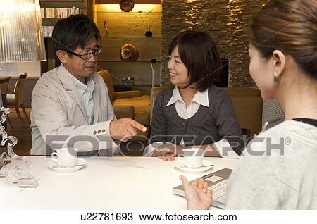 Middle-aged Couple with Consultant View Large Photo Image Stock Image - Middle-aged Couple with Consultant. Fotosearch