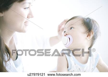 Stock Image - Mother and baby looking at each other. Fotosearch