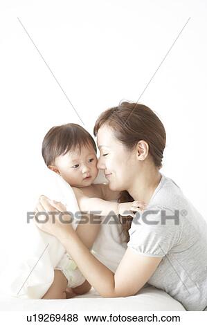 Mother hugging a crying baby View Large Photo Image Stock Photo - Mother hugging a crying baby. Fotosearch