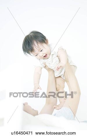 Mother lifting baby View Large Photo Image Stock Image - Mother lifting baby. Fotosearch