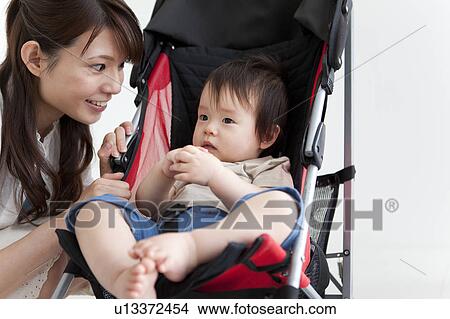 Mother Smiling at Baby Boy in Buggy View Large Photo Image Picture - Mother Smiling at Baby Boy in Buggy. Fotosearch