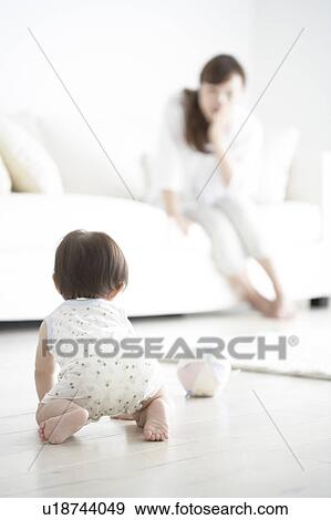 Mother watching baby crawl View Large Photo Image Stock Photo - Mother watching baby crawl. Fotosearch