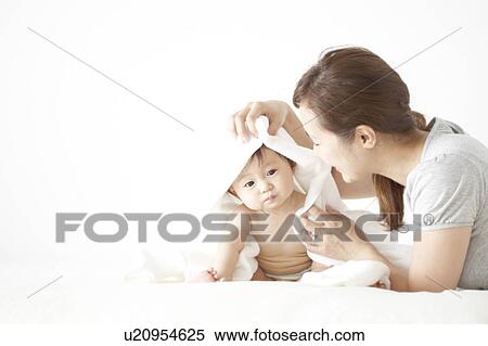 Mother wiping baby with towel View Large Photo Image Stock Photography - Mother wiping baby with towel. Fotosearch