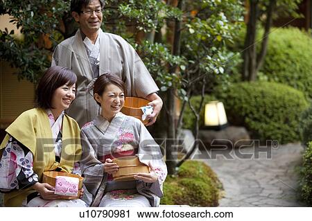 Stock Image - Parents and Their Adult Daughter in Spa. Fotosearch