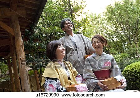 Stock Image - Parents and Their Adult Daughter in Spa. Fotosearch