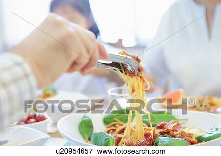 Stock Photo - Person Having Spaghetti. Fotosearch