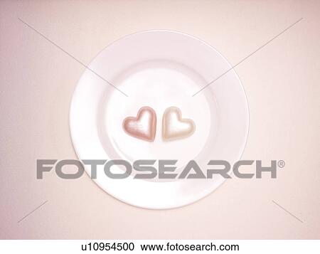 Stock Image - Pink Heart Shaped Candles on Plate. Fotosearch