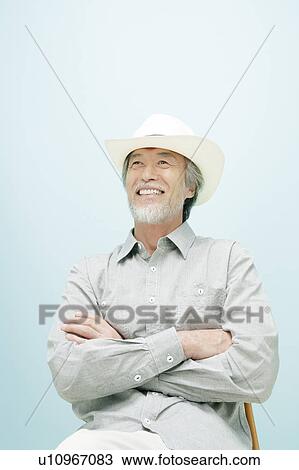 Stock Image - Portrait of Mature Man Wearing Hat. Fotosearch