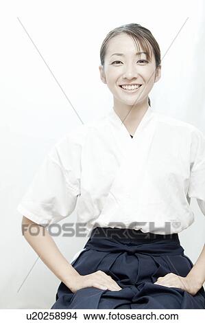 Picture - Portrait of woman wearing Kyudo (Japanese art of archery) uniform, Tokyo Prefecture, Japan. Fotosearch