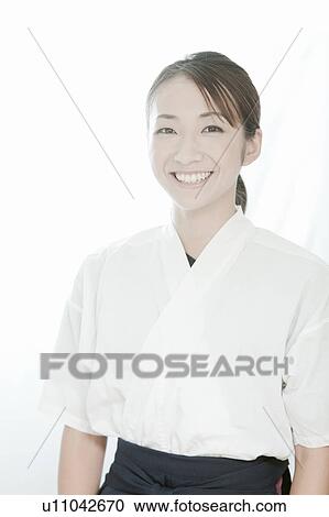 Stock Image - Portrait of woman wearing Kyudo (Japanese art of archery) uniform, Tokyo Prefecture, Japan. Fotosearch