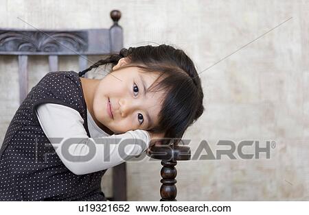 Portrait of Young Girl Sitting on Chair View Large Photo Image Stock Image - Portrait of Young Girl Sitting on Chair. Fotosearch